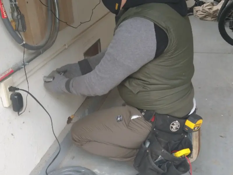 Electrician performing outlet wiring in a Shapleigh garage